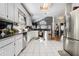 Bright kitchen boasts tile floors, stainless appliances, granite countertops, and ample cabinet space at 102 Prestwick S Way, Stockbridge, GA 30281