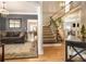 Inviting living room featuring hardwood floors, plush sofa, staircase, and elegant decor at 102 Prestwick S Way, Stockbridge, GA 30281