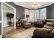 Comfortable living room with plush seating, bay windows, and decorative accents at 102 Prestwick S Way, Stockbridge, GA 30281