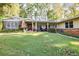 Ranch style home with stone accents, covered porch, and manicured lawn at 2886 Cardinal Lake Cir, Duluth, GA 30096