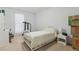 Bright bedroom featuring a white bed, neutral carpet, and minimalist decor at 245 Fern Crest Dr, Lawrenceville, GA 30046