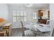 Bright dining area with white shutters and table; boxes sit in the corner at 245 Fern Crest Dr, Lawrenceville, GA 30046