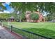 Historic brick building with well-manicured lawn, framed by mature trees and a charming gazebo, showcasing timeless appeal at 245 Fern Crest Dr, Lawrenceville, GA 30046