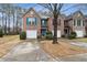 Brick townhome featuring colorful shutters and a well-maintained front yard at 245 Fern Crest Dr, Lawrenceville, GA 30046