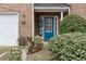 Charming entryway featuring a bright blue front door and lush landscaping at 245 Fern Crest Dr, Lawrenceville, GA 30046