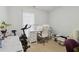 Functional home office with a white desk, ergonomic chair, and ample natural light at 245 Fern Crest Dr, Lawrenceville, GA 30046