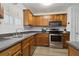 This kitchen features stainless steel appliances, wood cabinets, and hard surface countertops at 245 Fern Crest Dr, Lawrenceville, GA 30046