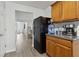 Traditional kitchen space with dark refrigerator and adjacent cabinets with light countertop at 245 Fern Crest Dr, Lawrenceville, GA 30046