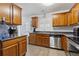 Well-equipped kitchen with wood cabinetry and stainless steel appliances at 245 Fern Crest Dr, Lawrenceville, GA 30046