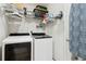 Laundry room featuring white front load washer and dryer, and plenty of storage space at 245 Fern Crest Dr, Lawrenceville, GA 30046