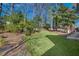 Landscaped backyard offering a large grassy area surrounded by trees at 40 Rhodes Dr, Marietta, GA 30068