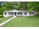 White brick ranch house with a landscaped lawn and walkway at 40 Rhodes Dr, Marietta, GA 30068