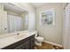 Clean bathroom with shower/tub combo, updated vanity, and honey-comb tile floor at 5352 Waterford Dr, Dunwoody, GA 30338