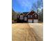 Brick house with two-car garage and a landscaped yard at 608 Morgans Trce, Ellenwood, GA 30294