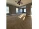 Large living room with neutral walls and carpet, and a ceiling fan at 608 Morgans Trce, Ellenwood, GA 30294