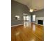 Living room with hardwood floors, fireplace, and view into kitchen at 608 Morgans Trce, Ellenwood, GA 30294