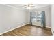 Well-lit bedroom with hardwood floors and teal curtains at 763 Windy Sw Dr, Stone Mountain, GA 30087