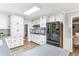 Bright kitchen with white cabinets, black appliances, and gray countertops at 763 Windy Sw Dr, Stone Mountain, GA 30087