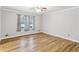 Light-filled living room with hardwood floors and large windows at 763 Windy Sw Dr, Stone Mountain, GA 30087