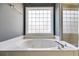 Bathroom with jetted tub and large window at 9415 Grande Dr, Winston, GA 30187