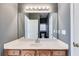 Bathroom with a large mirror, wooden cabinets, and a sink, offering a bright and functional space at 9415 Grande Dr, Winston, GA 30187