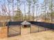 A fenced-in dog kennel in a lush back yard offering pets safe outdoor enjoyment at 9415 Grande Dr, Winston, GA 30187