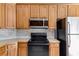 Kitchen with wood cabinets and tile backsplash at 9415 Grande Dr, Winston, GA 30187