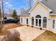 Patio with tiled surface, view of the home's exterior, and well-maintained landscape, for relaxation and outdoor living at 9415 Grande Dr, Winston, GA 30187