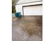 White garage door with cracked driveway and recycling bins at 106 June Ct, Hampton, GA 30228