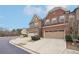 Exterior view of townhome community, showcasing a brick townhome with a driveway at 2084 Wheylon Dr, Lawrenceville, GA 30044