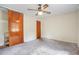 Bedroom with ceiling fan, wood closet doors, and neutral carpeting at 2907 Renfro Nw Dr, Atlanta, GA 30318