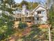 White two story house with large deck and wooded setting at 3268 Teton Se Dr, Atlanta, GA 30339