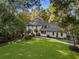 Stunning white house nestled in lush greenery, showcasing a manicured lawn and brick pathway at 5735 Winterthur Ln, Atlanta, GA 30328