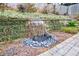 Serene backyard water feature with stonework and lush greenery at 12265 Magnolia Crescent Dr, Roswell, GA 30075