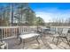 Deck with seating area, glass-top table, and wooded views at 3970 Somerled Trl, Atlanta, GA 30349