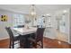 Dining room with marble table, four chairs, and an open view to the kitchen at 3970 Somerled Trl, Atlanta, GA 30349