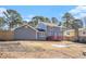 House's back view, showcasing a deck and large backyard at 501 Fond Du Lac Dr, Stone Mountain, GA 30088