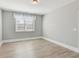 Spacious bedroom with light gray walls and wood-look flooring at 5110 Meridian Pass, Cumming, GA 30028