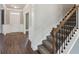 Bright entryway with hardwood floors and staircase with iron railing at 5110 Meridian Pass, Cumming, GA 30028