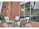 Outdoor patio seating area with four chairs and a table, on a brick patio at 572 Edgewood Ne Ave # 309, Atlanta, GA 30312