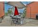Rooftop patio seating area with patio umbrella and string lights at 572 Edgewood Ne Ave # 309, Atlanta, GA 30312