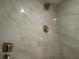 Shower featuring light marble tile and modern shower head at 572 Edgewood Ne Ave # 309, Atlanta, GA 30312
