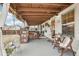 Covered back porch with seating area and outdoor dining space at 7 Little Creek Manor Dr, Dallas, GA 30157