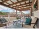 Relaxing covered back porch with seating area and wood pergola at 7 Little Creek Manor Dr, Dallas, GA 30157