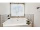 Relaxing bathroom with soaking tub, tile surround, and updated vanity at 7 Little Creek Manor Dr, Dallas, GA 30157