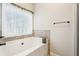 Bathroom with garden tub and neutral tile at 7 Little Creek Manor Dr, Dallas, GA 30157