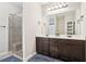 Double vanity bathroom with walk-in shower and dark brown cabinets at 7 Little Creek Manor Dr, Dallas, GA 30157