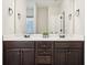 Double vanity bathroom with dark brown cabinets and quartz countertops at 7 Little Creek Manor Dr, Dallas, GA 30157