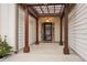 Covered entryway with pergola and a charming front door at 7 Little Creek Manor Dr, Dallas, GA 30157