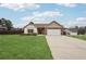 Ranch home with stone accents, two-car garage, and landscaped yard at 7 Little Creek Manor Dr, Dallas, GA 30157